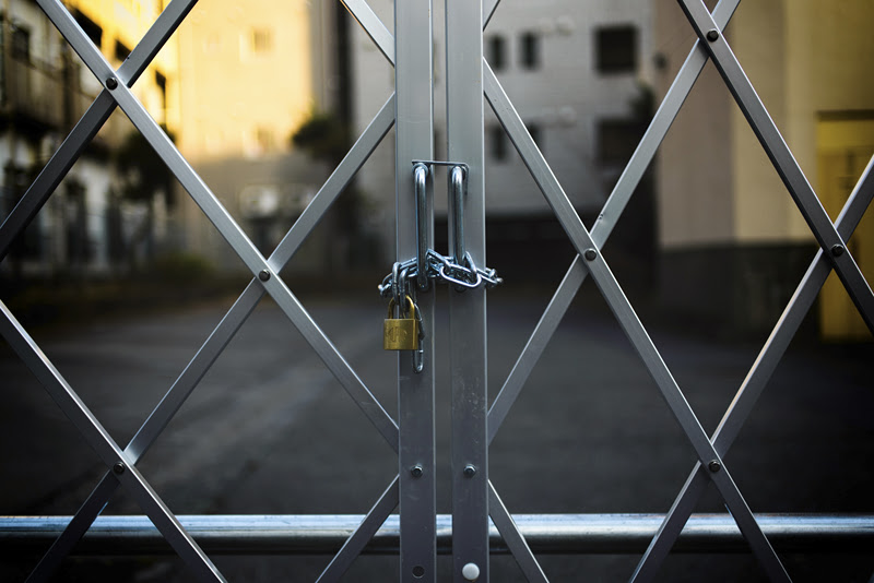A gate locked with chains and a padlock